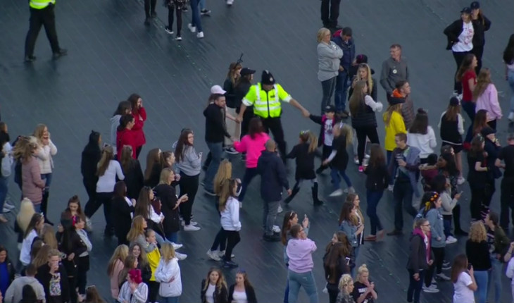 policial brincando com crianças durante o show da Ariana Grande