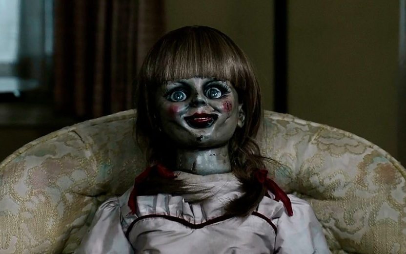 Boneca Annabelle sentada em sofá