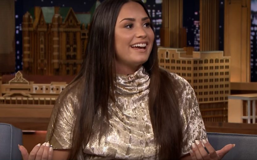 Demi Lovato usando vestido dourado no programa do Jimmy Fallon