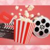 Balde de pipoca, claquete, ingresso e rolo de filme em fundo vermelho, representando a Semana do Cinema com ingressos promocionais.